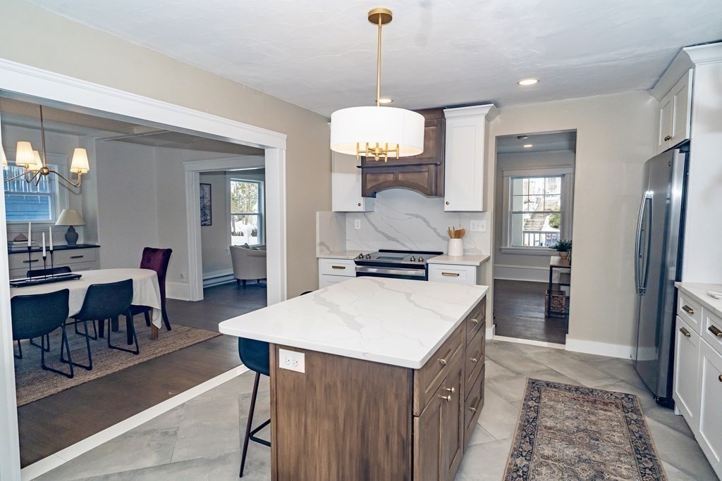 65 Hadwen Road Worcester, MA 01602 - Photo 19 of 38 a kitchen with a stove a refrigerator and a dining table
