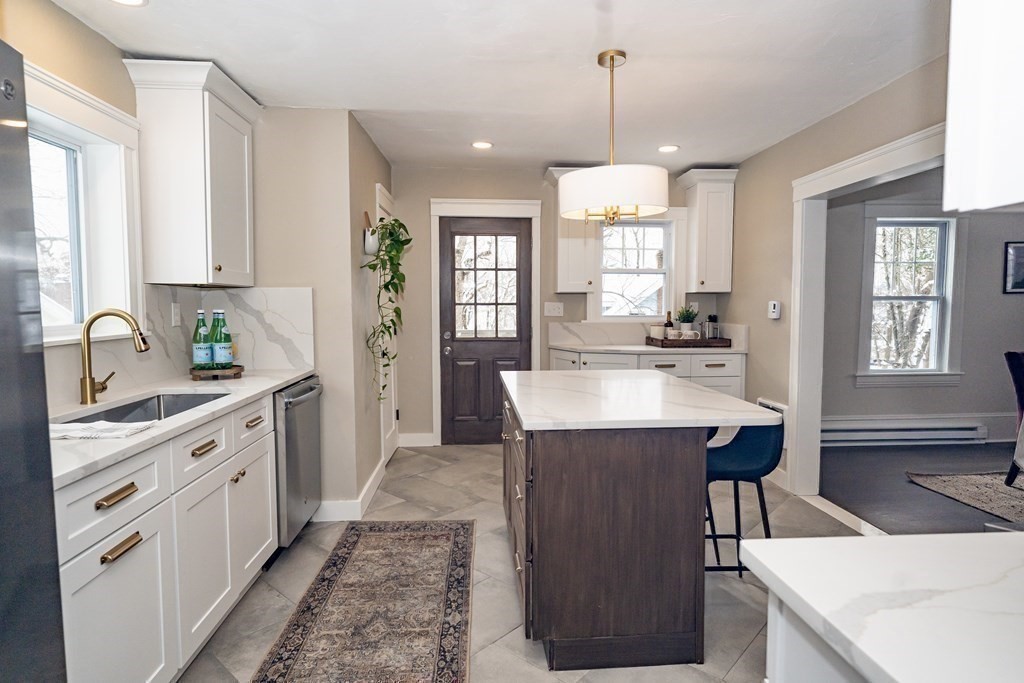 65 Hadwen Road Worcester, MA 01602 - Photo 20 of 38 a kitchen with stainless steel appliances kitchen island a sink stove and cabinets