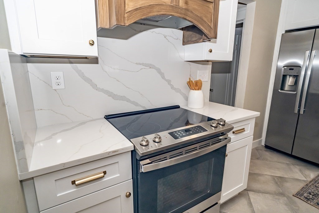 65 Hadwen Road Worcester, MA 01602 - Photo 21 of 38 a stove top oven sitting inside of a kitchen