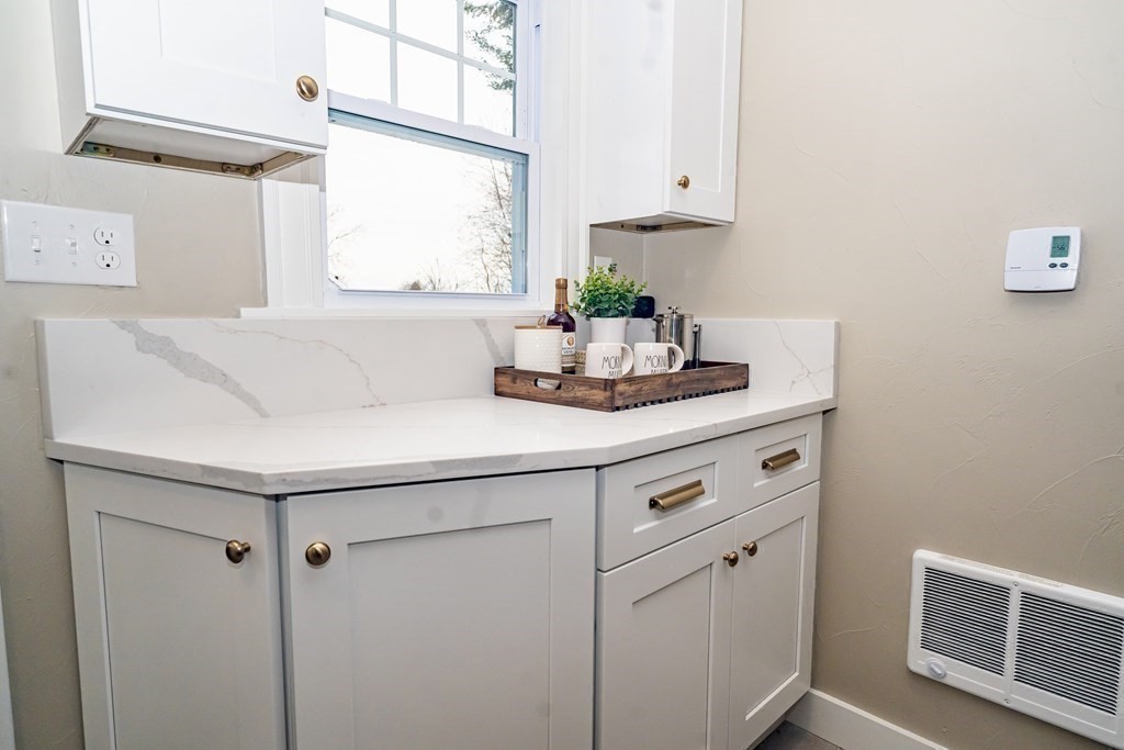 65 Hadwen Road Worcester, MA 01602 - Photo 22 of 38 a kitchen with stainless steel appliances cabinets and a window
