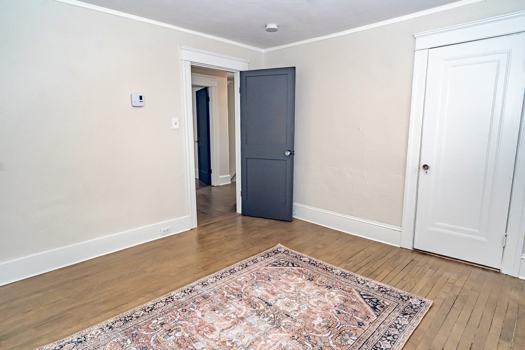 65 Hadwen Road Worcester, MA 01602 - Photo 29 of 38 an empty room with wooden floor and bathroom
