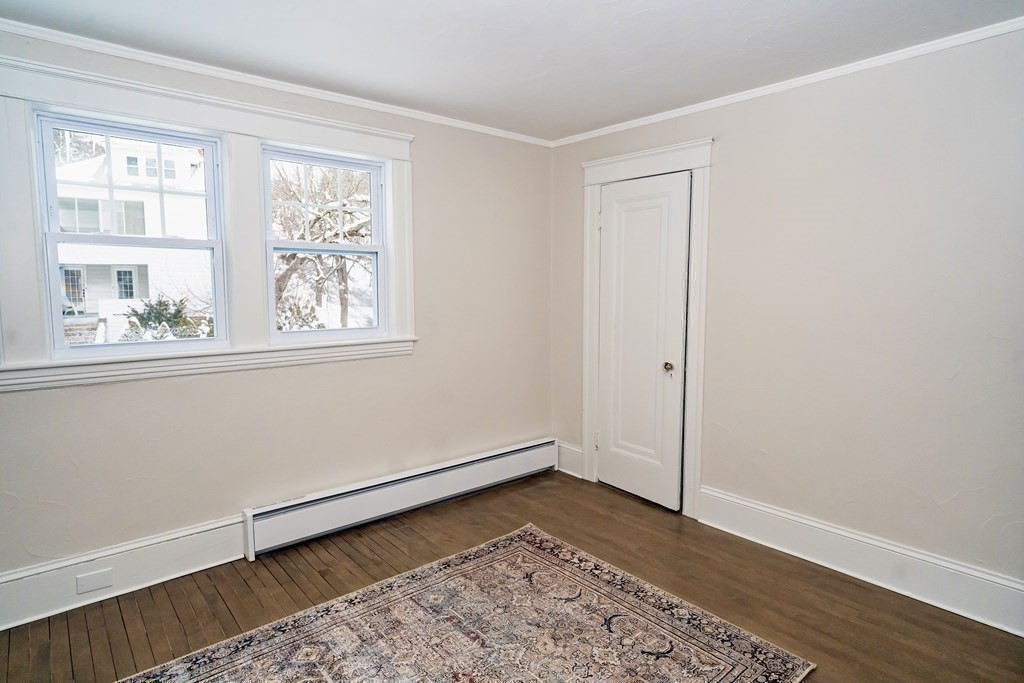 65 Hadwen Road Worcester, MA 01602 - Photo 32 of 38 an empty room with wooden floor and window