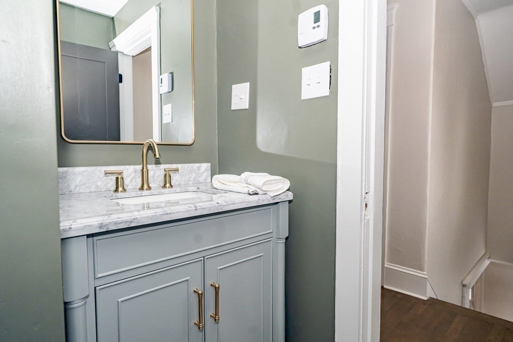 65 Hadwen Road Worcester, MA 01602 - Photo 35 of 38 a bathroom with a granite countertop sink and a mirror
