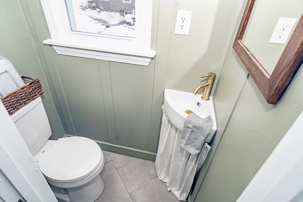 65 Hadwen Road Worcester, MA 01602 - Photo 37 of 38 a white toilet sitting next to a small bathroom