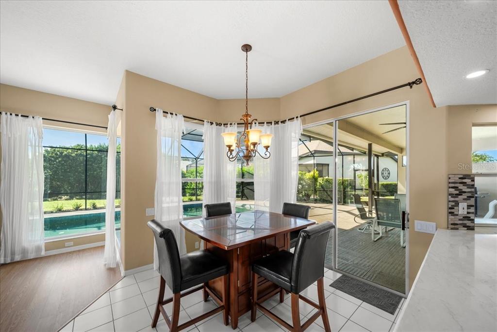 4321 Presidential Ave Circle East Bradenton, FL 34203 - Photo 12 of 49 a view of a dining room and livingroom with furniture wooden floor a chandelier