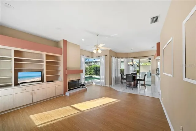 a living room with furniture a fireplace and a floor to ceiling window