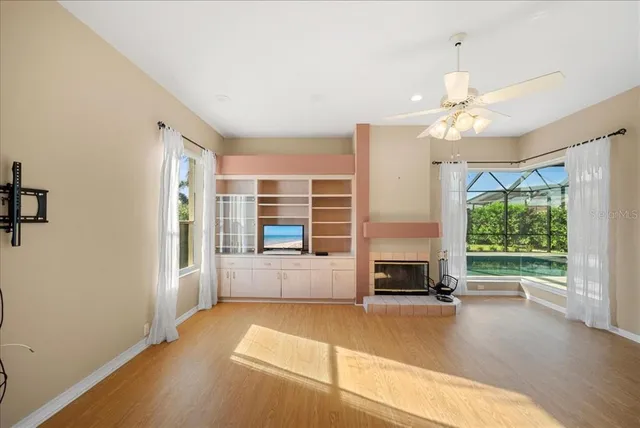 a living room with a fireplace furniture and a large window
