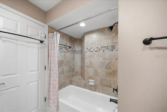 a bathroom with a shower and a tub