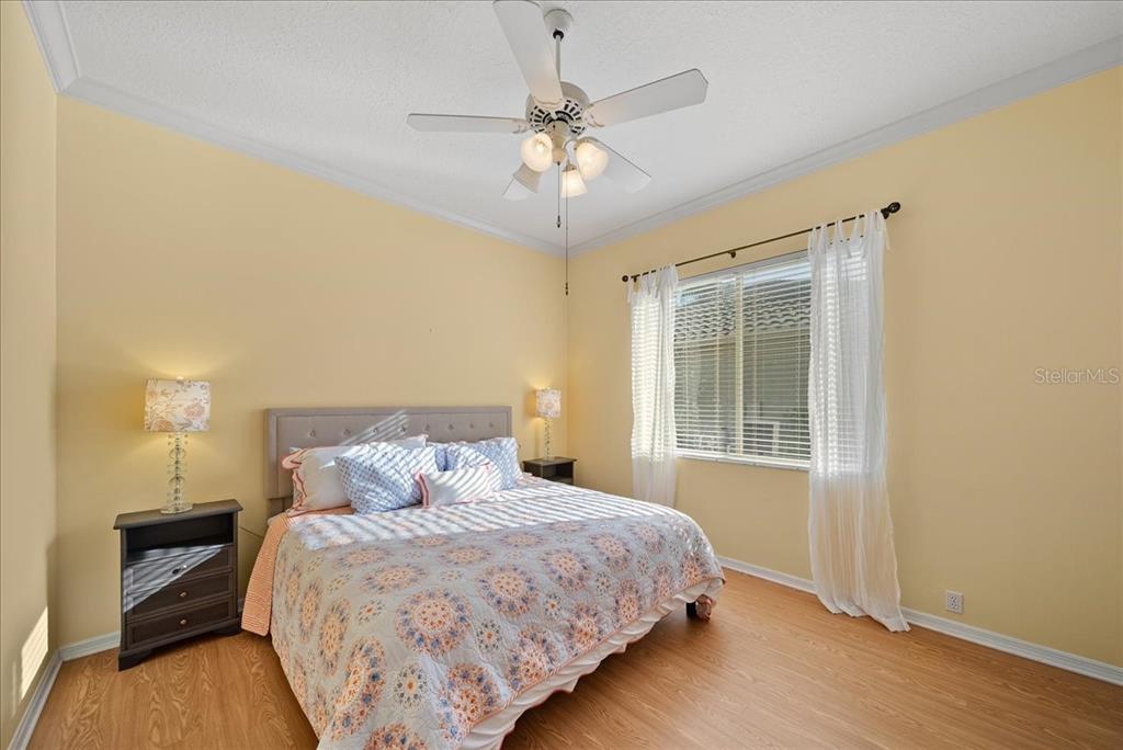 4321 Presidential Ave Circle East Bradenton, FL 34203 - Photo 20 of 49 a bedroom with a bed and a chandelier