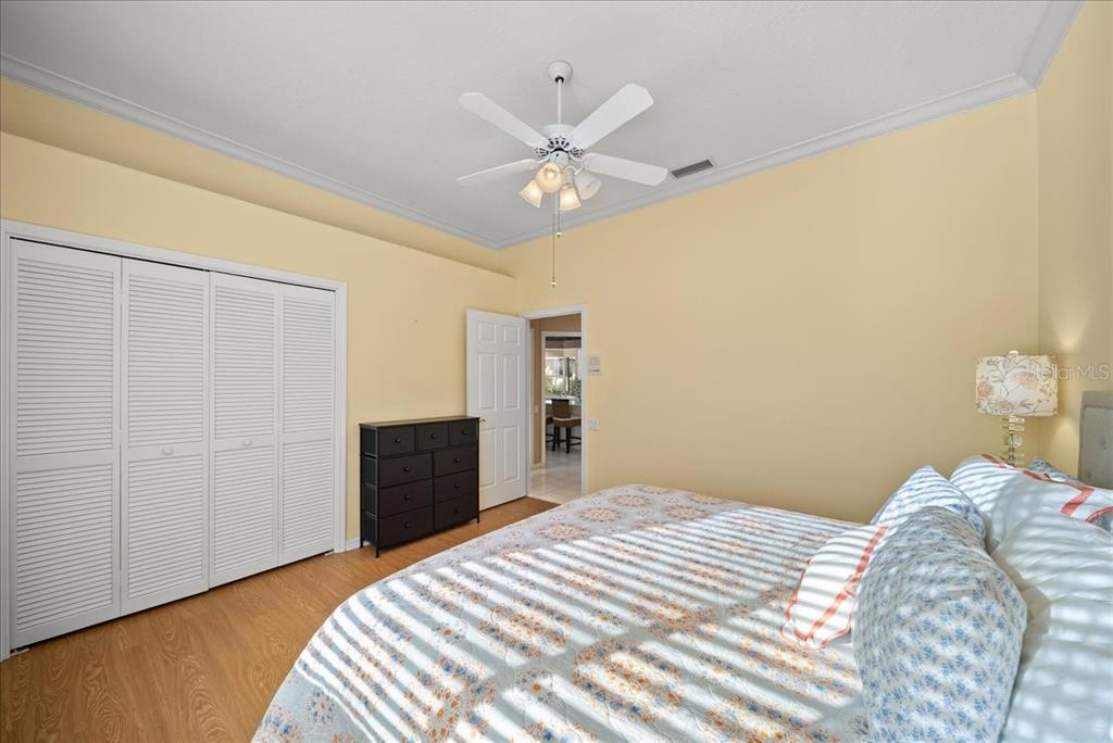4321 Presidential Ave Circle East Bradenton, FL 34203 - Photo 21 of 49 a bedroom with a bed and a chandelier