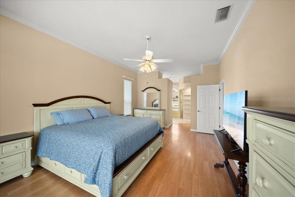 4321 Presidential Ave Circle East Bradenton, FL 34203 - Photo 24 of 49 a bedroom with a large bed and a chandelier