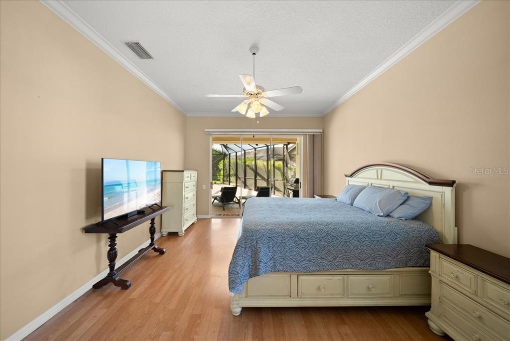 4321 Presidential Ave Circle East Bradenton, FL 34203 - Photo 25 of 49 a bedroom with a bed and a flat tv screen on dresser