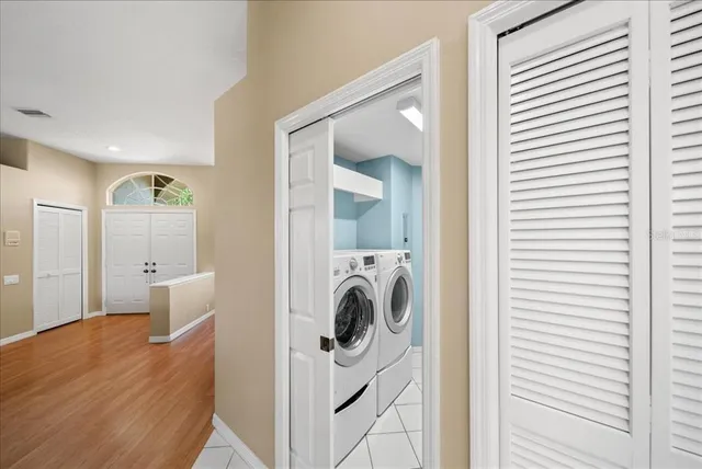 a view of a hallway with washer and dryer