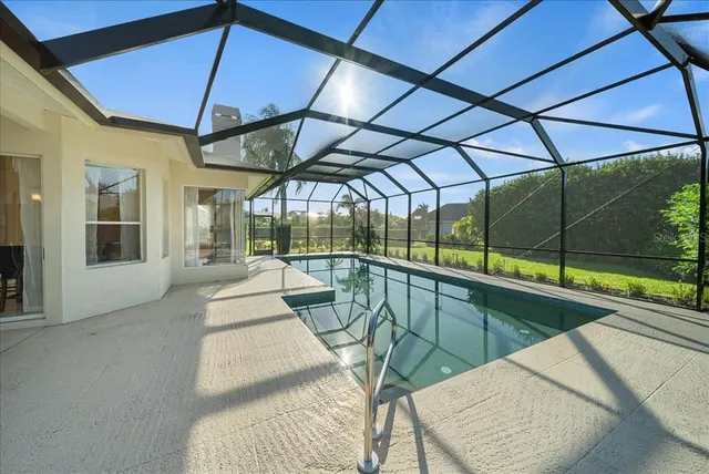 a view of a patio with a table and chairs under an umbrella