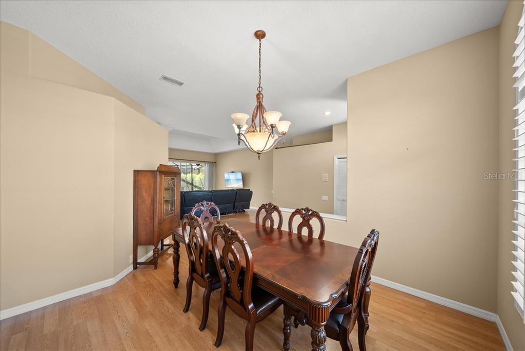 4321 Presidential Ave Circle East Bradenton, FL 34203 - Photo 5 of 49 a view of a dining room with furniture a chandelier and wooden floor
