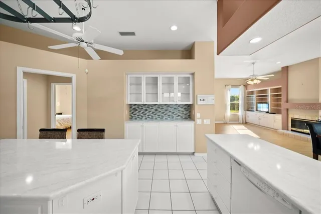 a large white kitchen with a large window