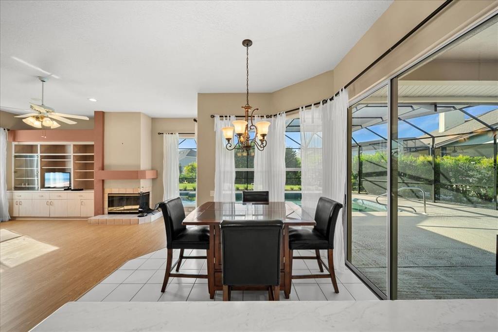 4321 Presidential Ave Circle East Bradenton, FL 34203 - Photo 10 of 49 a dining room with wooden floor a chandelier a glass table and chairs