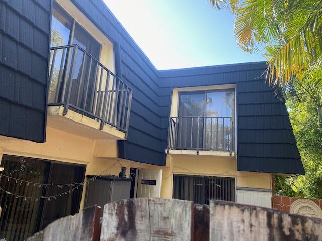 127 Woodland Road Palm Springs, FL 33461 - Photo 1 of 11 a view of a house with a wooden door