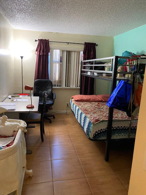 127 Woodland Road Palm Springs, FL 33461 - Photo 10 of 11 a bedroom with a bed and a desk