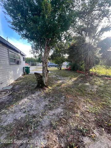 a view of a backyard with large trees