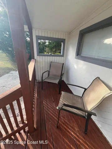 a view of balcony with furniture