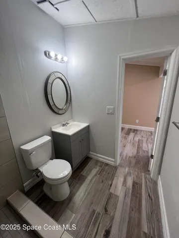 a bathroom with a toilet a sink and a mirror