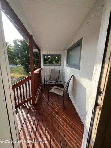 a view of two chairs in a balcony