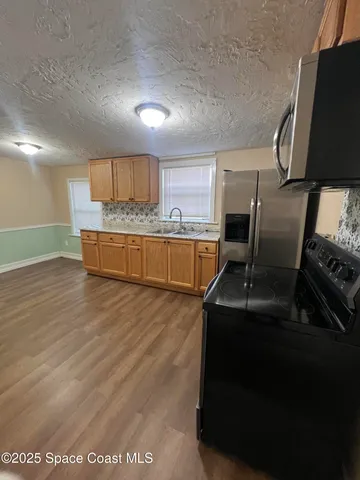 a kitchen with a sink and a stove top oven