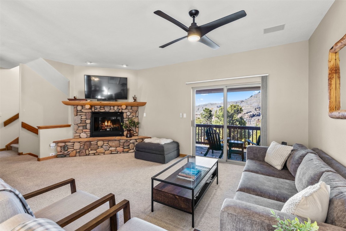 142 Lookout Ridge Drive Dillon, CO 80435 - Photo 3 of 39 Living room featuring a fireplace, ceiling fan and deck