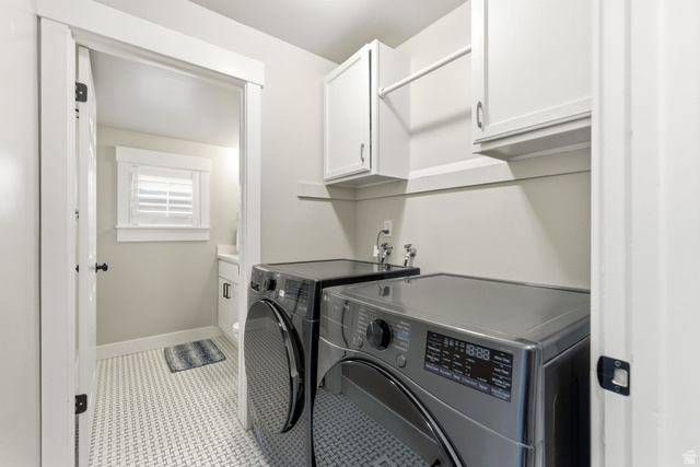 1405 Vintry Lane Murray, UT 84121 - Photo 33 of 44 Laundry area featuring white cabinetry, a hanging rod, and a utility sink