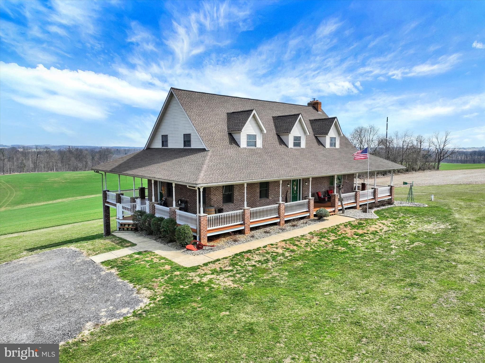 a view of a house with a big yard and a large tree