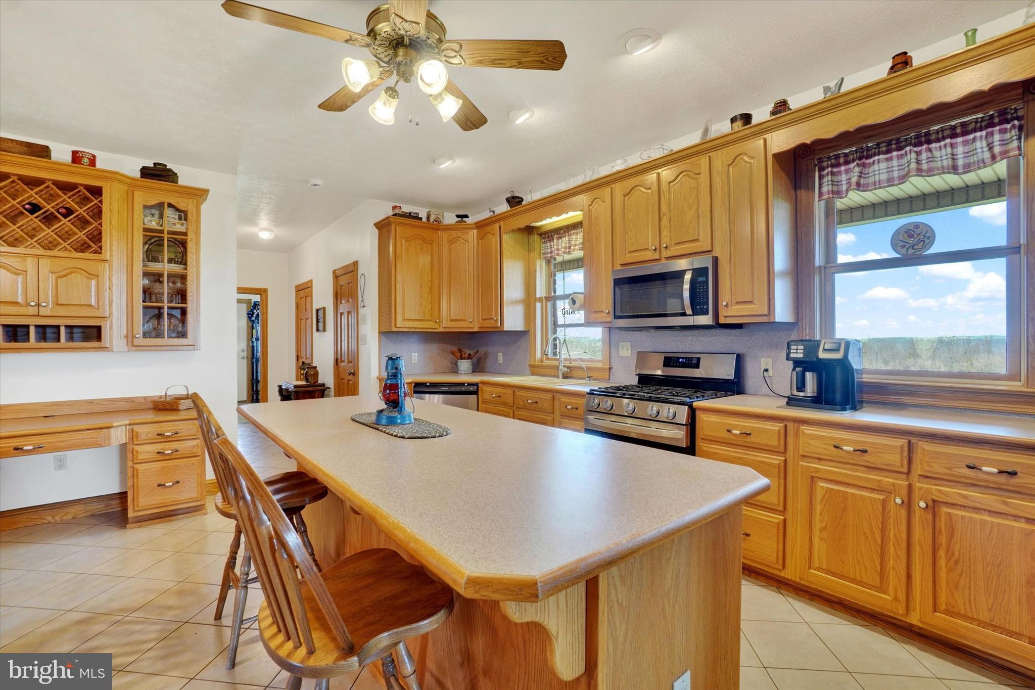 9185 High Rock Road New Park, PA 17352 - Photo 12 of 52 a kitchen with stainless steel appliances granite countertop a sink a stove a refrigerator cabinets and a dining table