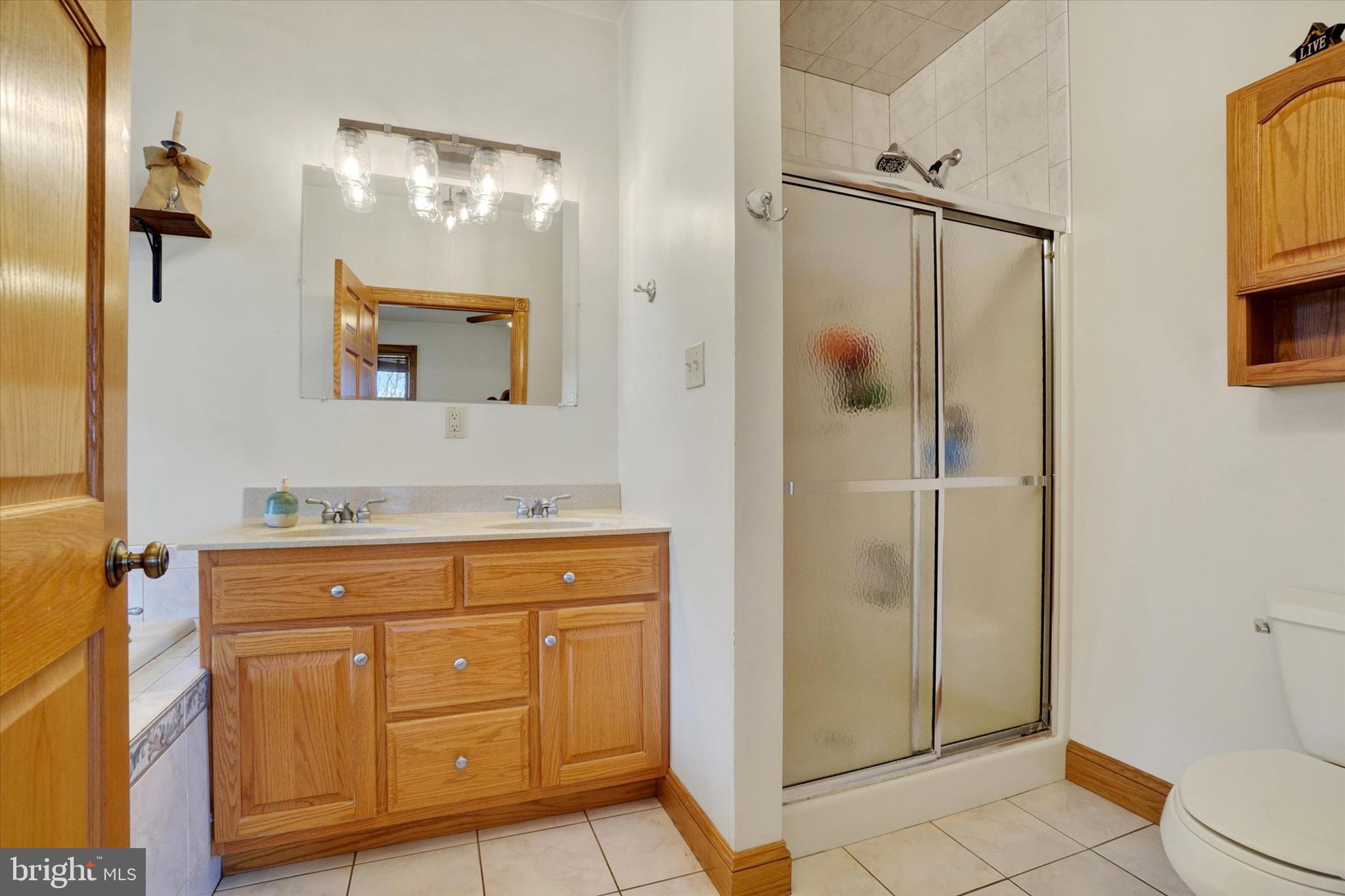 9185 High Rock Road New Park, PA 17352 - Photo 20 of 52 a bathroom with a shower sink and mirror