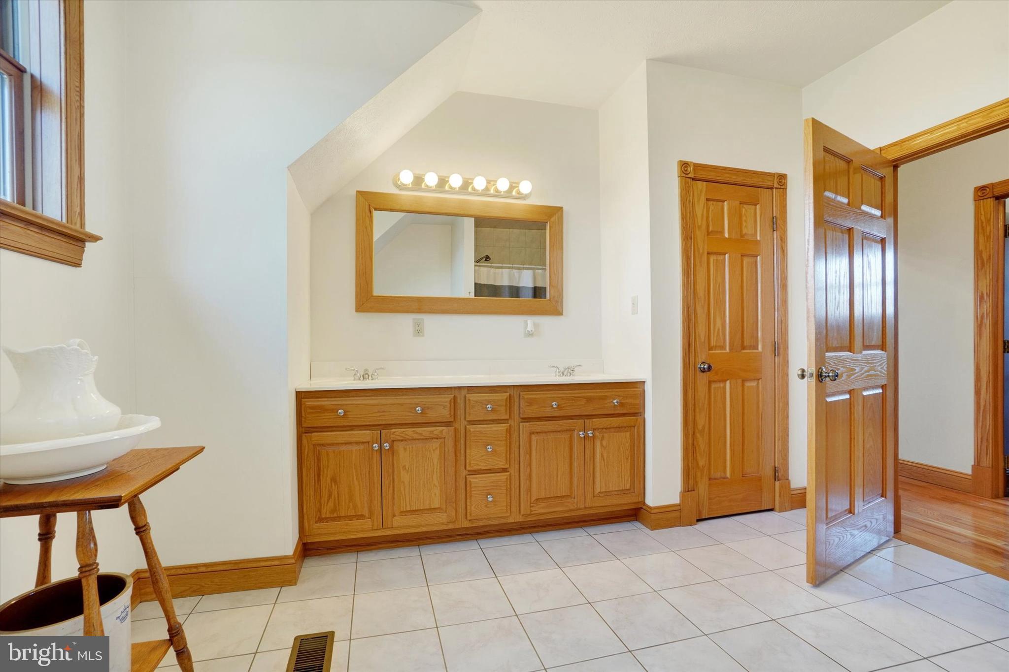 9185 High Rock Road New Park, PA 17352 - Photo 28 of 52 a spacious bathroom with a mirror sink and shower