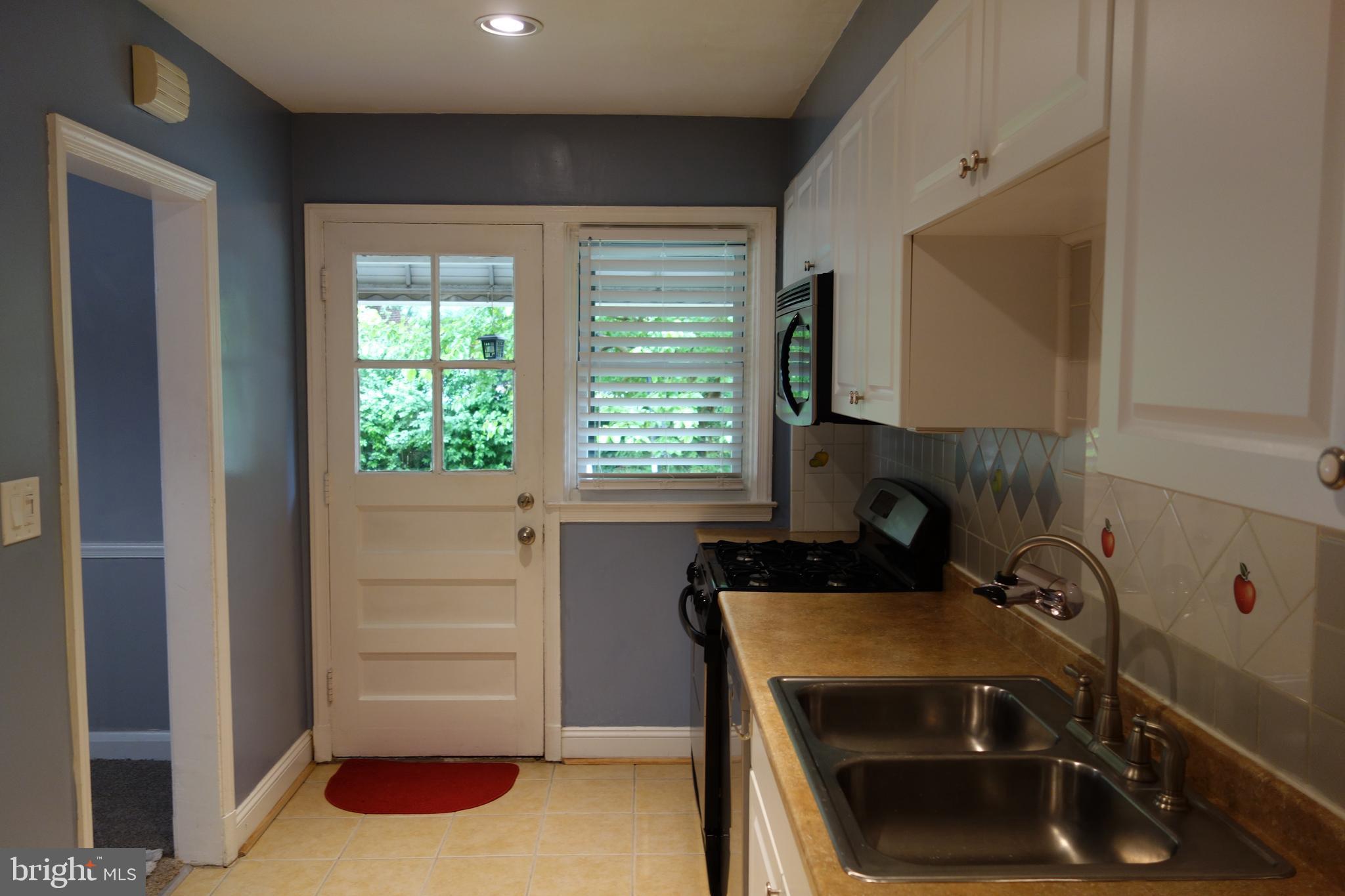 6641 Frederick Road Catonsville, MD 21228 - Photo 3 of 16 Kitchen to porch & Yard & Parking Pad