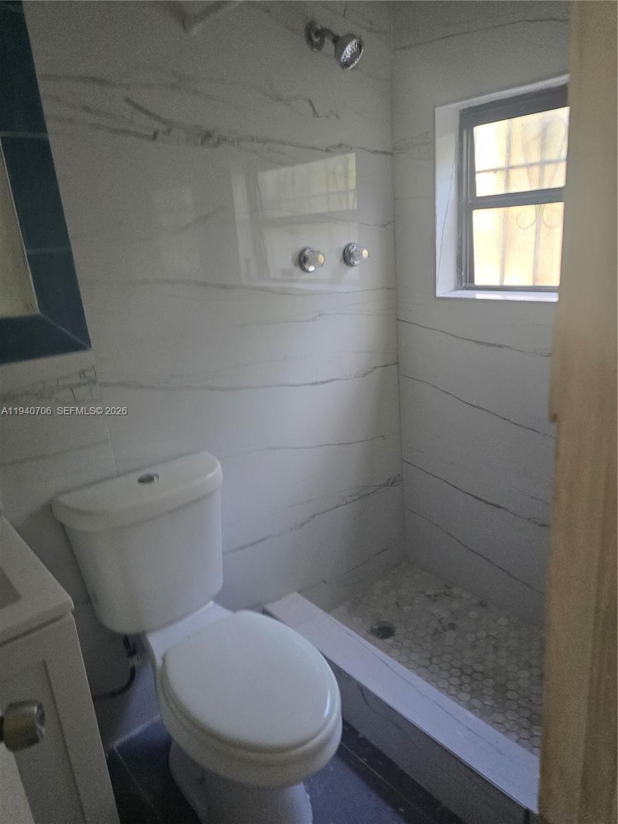 143 Northwest 69th Street, Unit 3 Miami, FL 33150 - Photo 5 of 7 a bathroom with a toilet and a shower