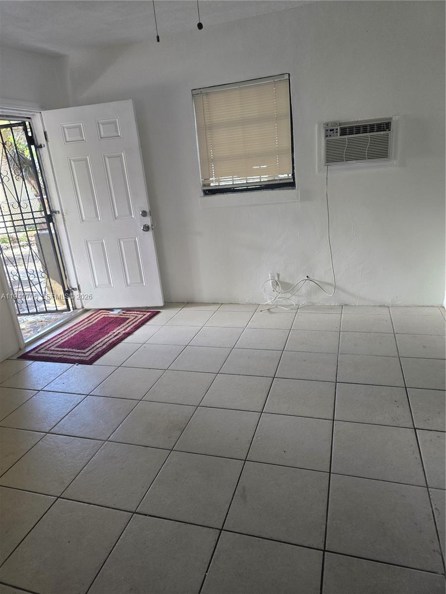 143 Northwest 69th Street, Unit 3 Miami, FL 33150 - Photo 6 of 7 a room with a bed