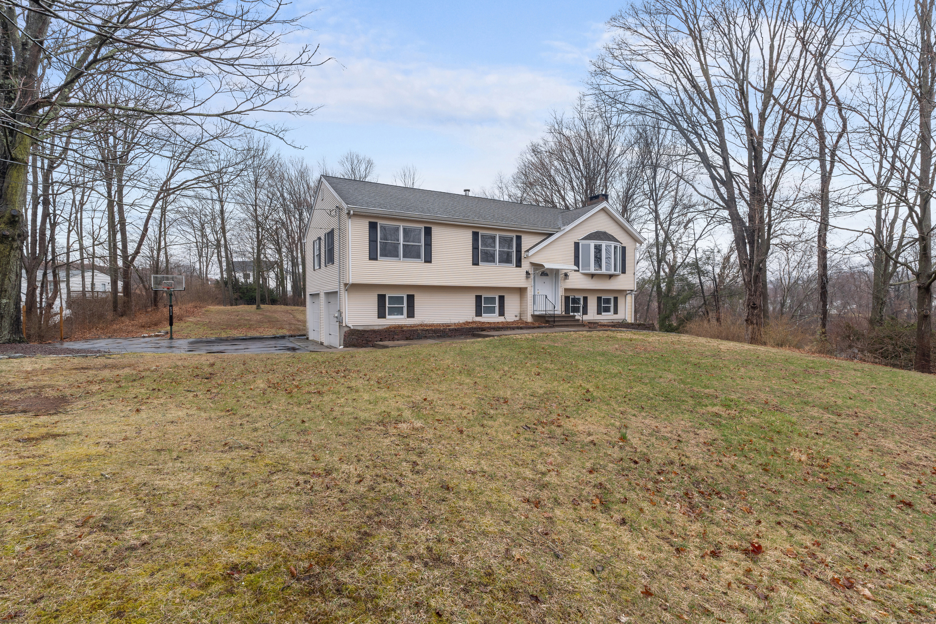 10 Mill Road North Branford, CT 06471 - Photo 1 of 33 a front view of a house with a yard covered with trees