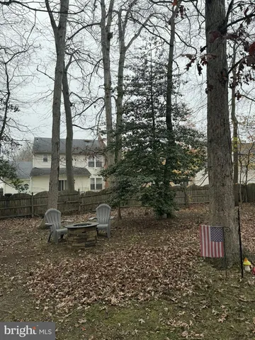 a view of staircase with lots of frames on wall and a large window