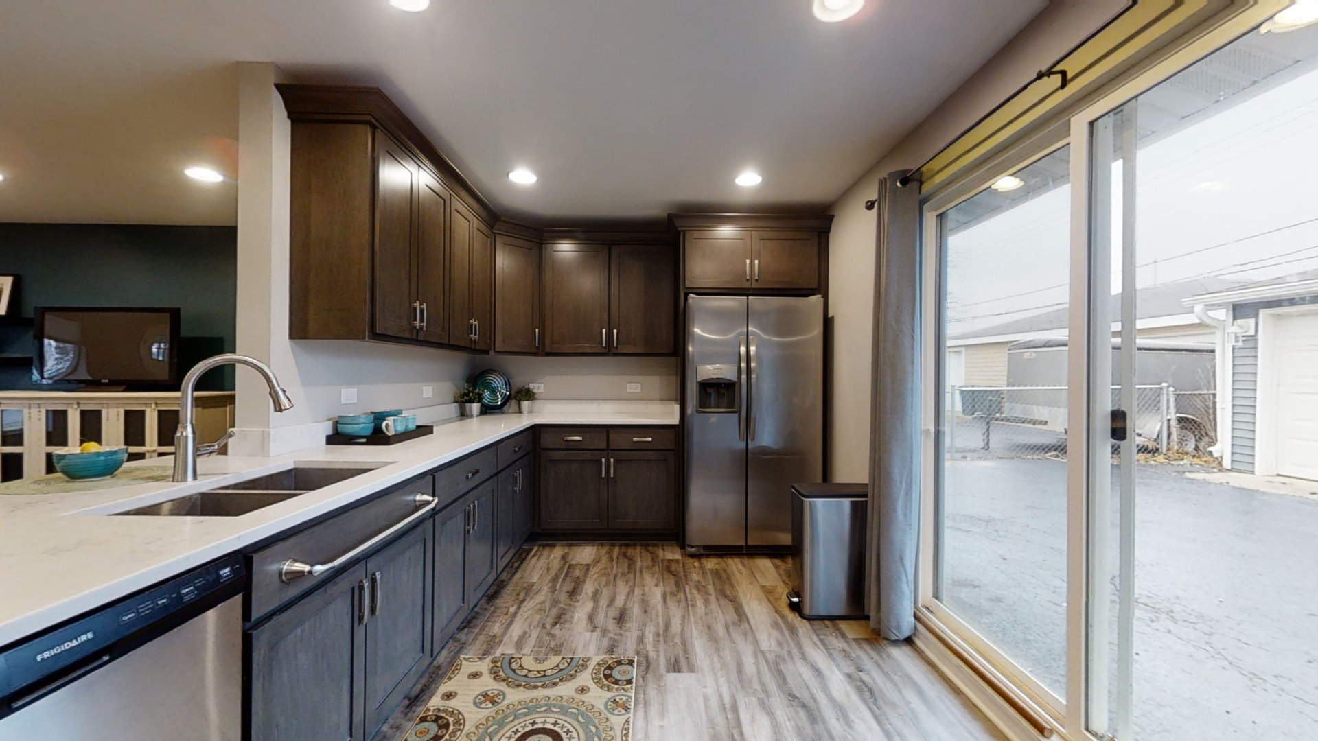 153 Queenswood Road Bolingbrook, IL 60440 - Photo 6 of 17 a kitchen with a refrigerator a sink and wooden floor
