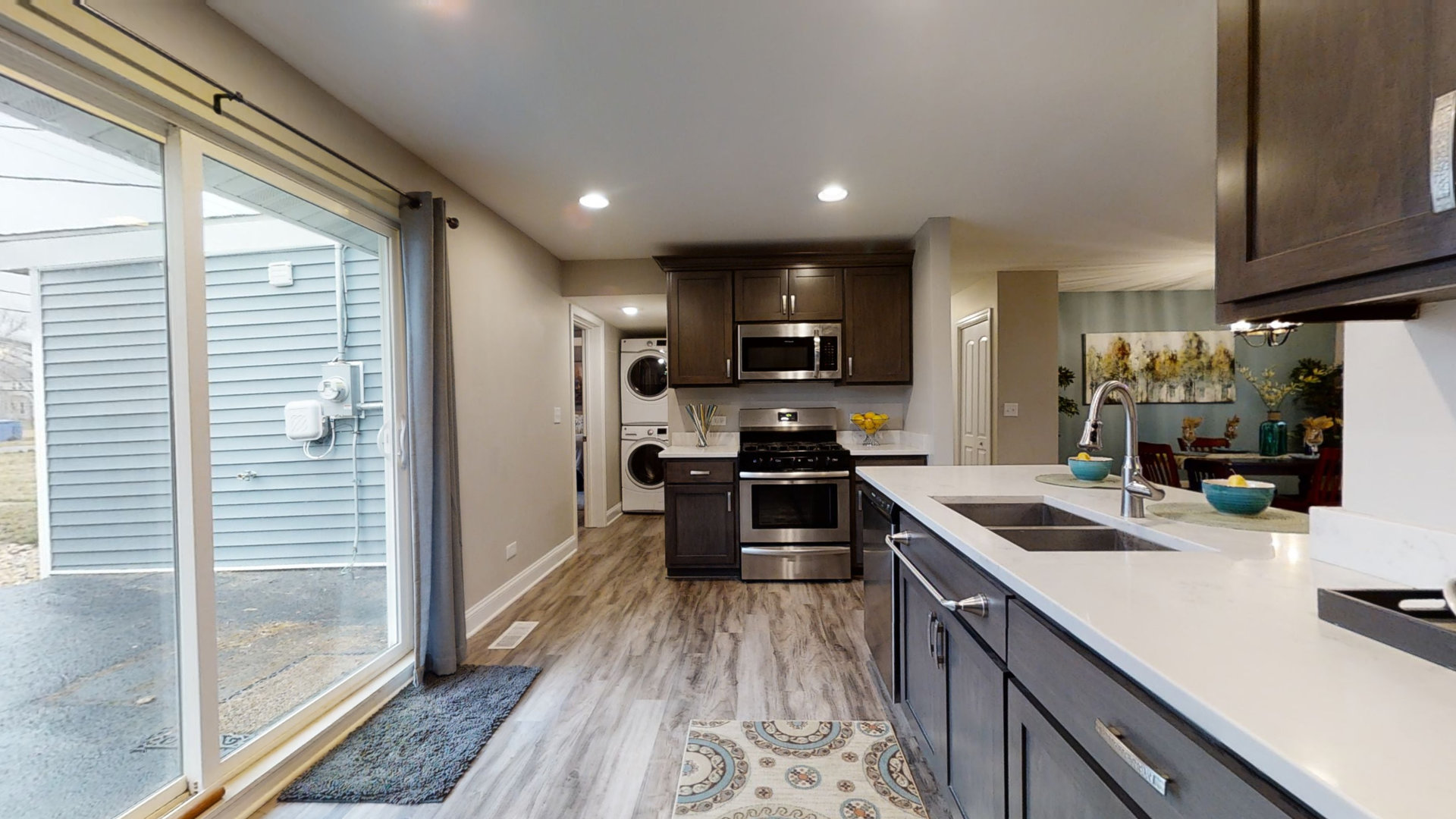 153 Queenswood Road Bolingbrook, IL 60440 - Photo 7 of 17 a kitchen with kitchen island granite countertop a sink cabinets and stainless steel appliances