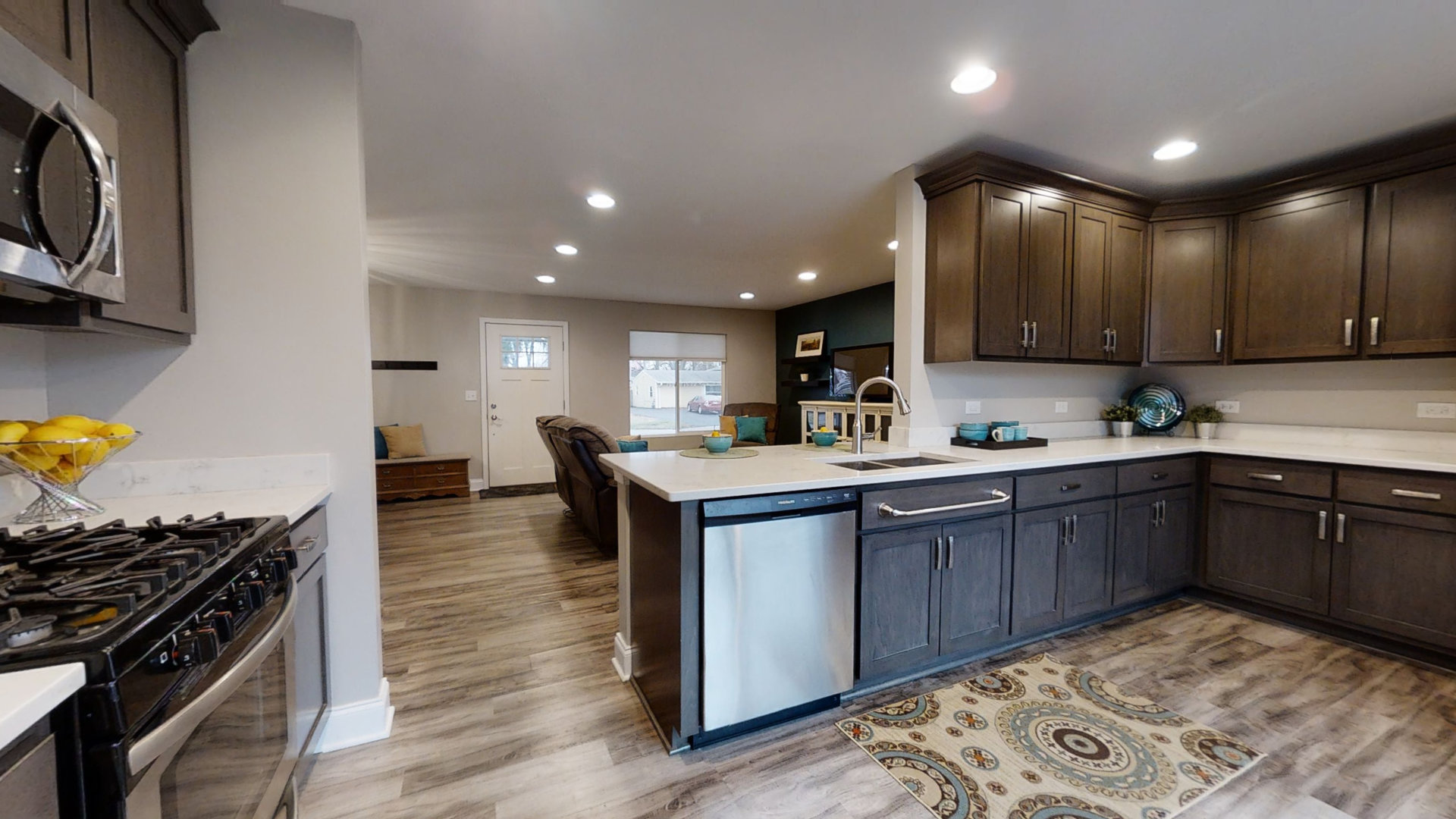 153 Queenswood Road Bolingbrook, IL 60440 - Photo 8 of 17 a kitchen with stainless steel appliances granite countertop a stove top oven a sink dishwasher and cabinets with wooden floor