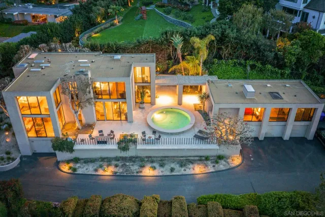 an aerial view of a house with swimming pool patio and outdoor seating
