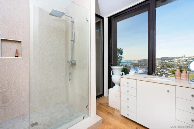 a view of bathroom with a large window and mirror