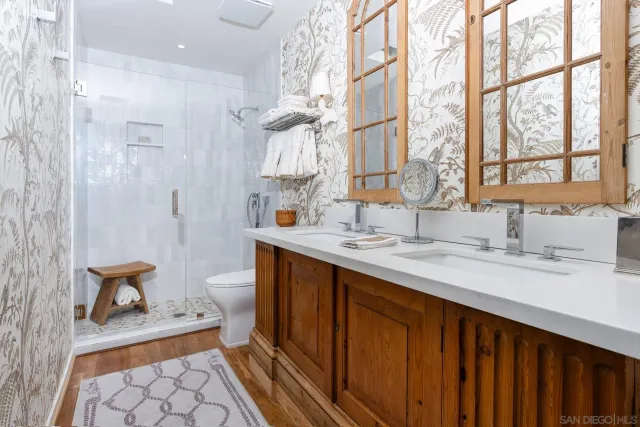 a bathroom with a sink double vanity and a shower