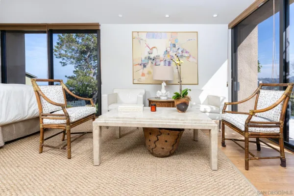a view of a dining room with furniture large windows and wooden floor
