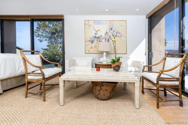 a view of a dining room with furniture large windows and wooden floor