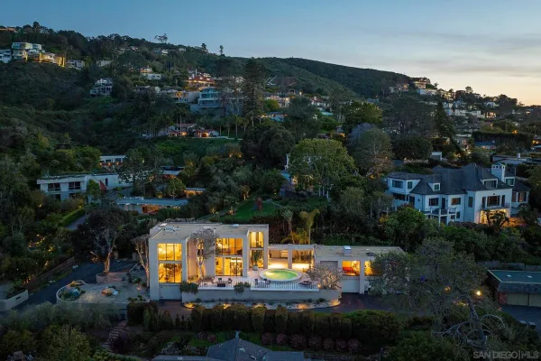 an aerial view of a house with a garden and swimming pool