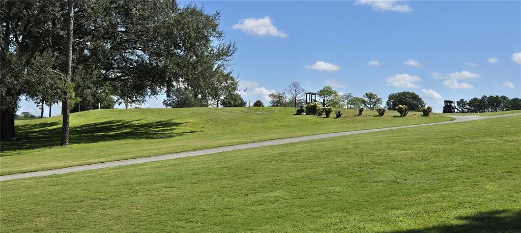 3935 Parway Road, Unit 1322 Zellwood, FL 32798 - Photo 16 of 28 a view of a golf course with a garden