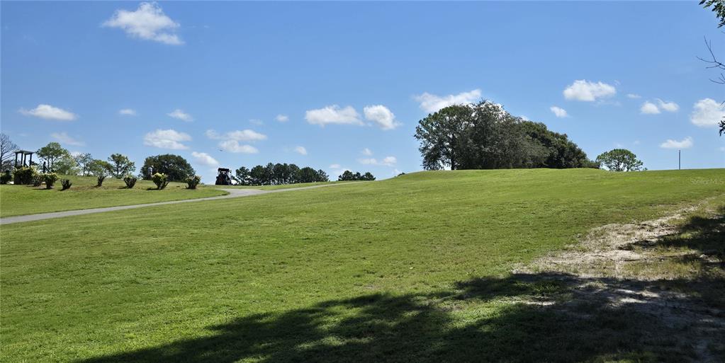 3935 Parway Road, Unit 1322 Zellwood, FL 32798 - Photo 17 of 28 a view of a golf course with a lake